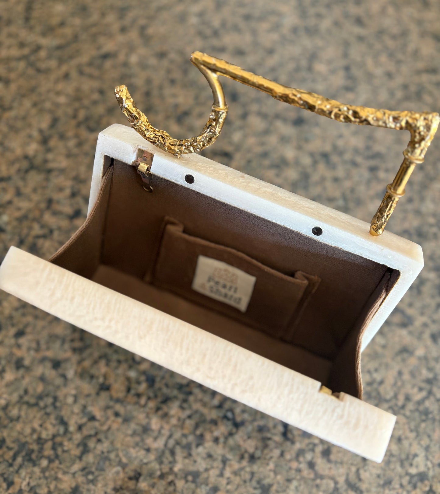 Sculpted Pearl-White Rectangle Clutch With Textured Gold Handle