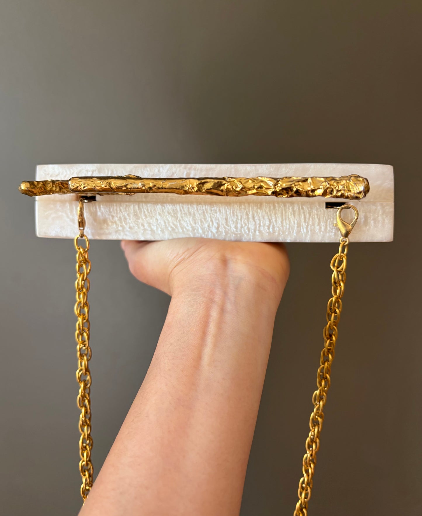 Sculpted Pearl-White Rectangle Clutch With Textured Gold Handle